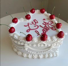 a white cake with cherries on top that says it's your birthday