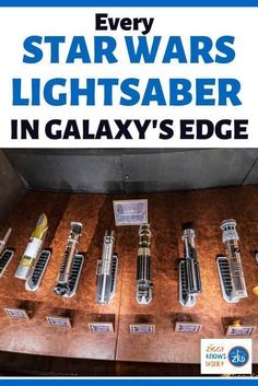 several star wars lightsaber in galaxy's edge display case with the title, every star wars light saber in galaxy's edge