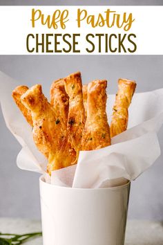 cheesy puff pastry sticks in a white cup with text overlay that reads, how to make puff pastry cheese sticks