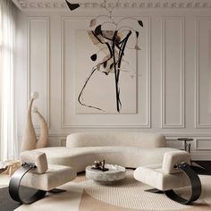 a living room with white furniture and art on the wall