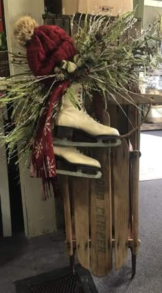 a pair of skis sitting on top of a wooden sled filled with plants