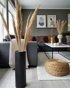 a living room filled with lots of furniture and decor on top of a hard wood floor