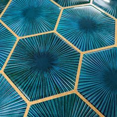 blue and gold tiles with starburst designs on them