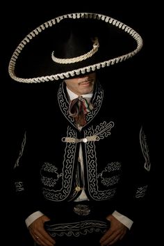 a man wearing a sombrero sitting down