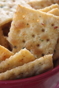 some crackers in a red bowl on a table