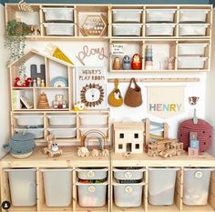 a wooden shelf filled with lots of toys and storage containers on top of it's sides