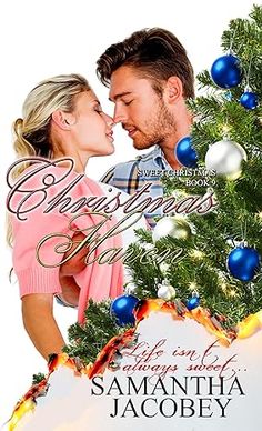 a man and woman kissing in front of a christmas tree