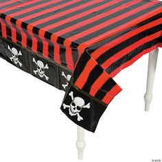 a pirate themed table cover with skull and crossbones on the front, black and red stripes