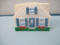 a small white house made out of plastic beads