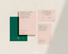 three pieces of pink and green paper on a white surface