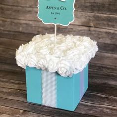 a blue box with white flowers and a cake topper