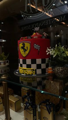 there is a cake that looks like a ferrari racing car on display in the store