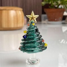 a small glass christmas tree on a table