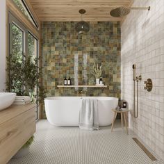 a bathroom with a tub, sink and toilet in it's center wall is made out of stone tiles