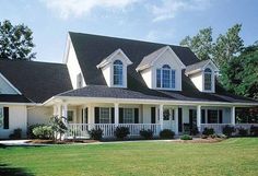 a large white house with black roof and windows