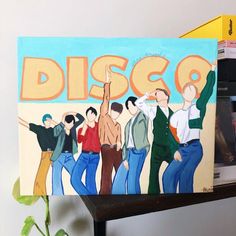 a painting of people dancing in front of the word disco on a wooden shelf next to books