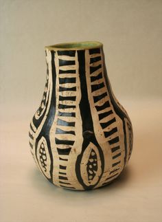 a black and white vase sitting on top of a table