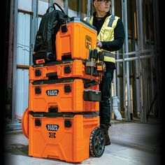 a man working on an orange tool box