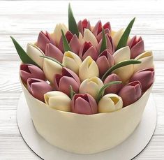 there is a cake decorated with tulips on the table