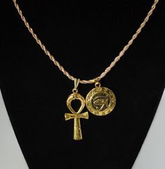 African Gold plated Duo Charm Necklace  One Large Ankh Charm and one Eye of Horus Shield Charm❤ Ankh measures 1.5 inches tall by 0.75 inches wide with a gold snap-on bale.❤ Eye of Horus Charm is 25mm wide and is hollow on back.Choose YOUR CHAIN from our pull-down menu:❤ {1} Rope Chain 2mm wide by 18 inches long with lobster clasp.OR❤ {1} Rope Chain 2mm wide by 20 inches long with lobster clasp.❤ Made-to-order and ships out from MAINE same day as ordered to USA.❤ Every order includes a FREE GIFT! Eye Of Horus Necklace, African Gold, Egyptian Necklace, Husband Valentine, Valentine Gifts For Husband, Gold Rope Chains, Birthday Gifts For Husband, Eco Gifts, Bangor