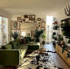 a living room filled with furniture and lots of plants