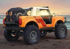 an orange and white truck parked on top of a beach next to the ocean at sunset