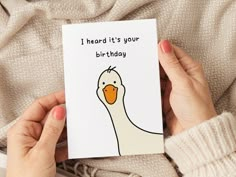 a person holding a card with a duck on it that says, i heard it's your birthday