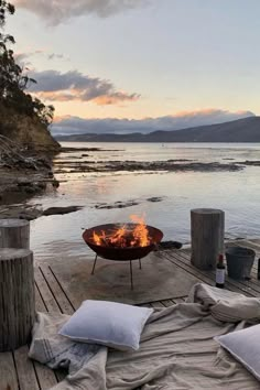 a fire pit sitting on top of a wooden dock