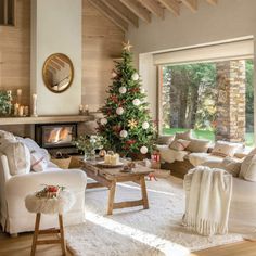 a living room filled with furniture and a christmas tree in the middle of the room