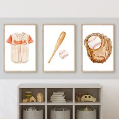 three pictures of baseballs and bats on the wall in a child's room