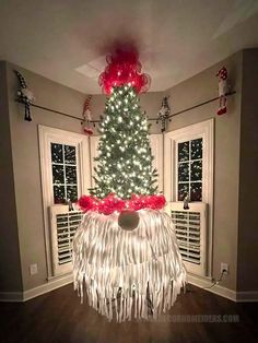 a christmas tree is decorated with red and white lights