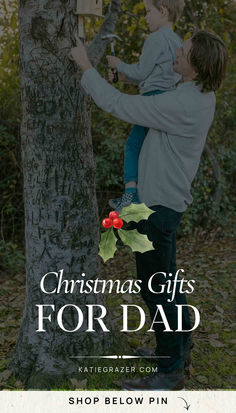 a man holding a child up to a tree with the words christmas gifts for dad on it