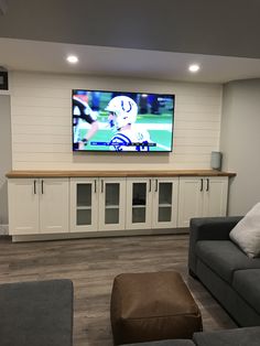 a large flat screen tv mounted to the side of a wall in a living room