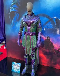 a costume on display in front of a wall with an advertisement for the movie's avatar