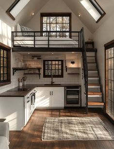 an open loft with stairs leading up to the kitchen