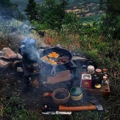 an outdoor grill with food cooking on it