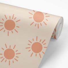 an orange and white wallpaper with small sun designs on it's side,