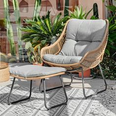 a wicker chair and footstool sitting on a patio with potted plants in the background