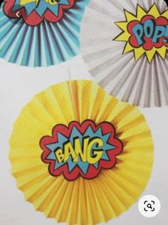 three paper fan shaped like pop art with the word bang on it's center