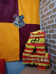 a harry potter pinata sitting on top of a wooden table next to a brick wall