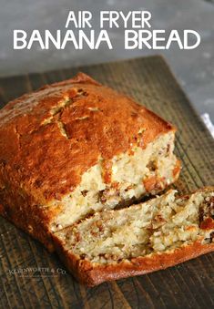 an air fryer banana bread cut in half on top of a wooden cutting board