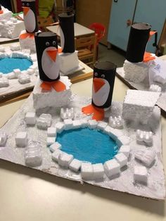 penguins made out of ice cubes sitting on top of a table