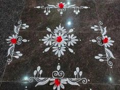 a black marble floor with white and red designs on the ground in front of it