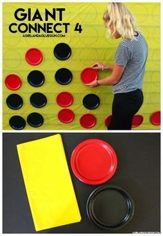 a woman standing in front of a giant board with red and black plates on it