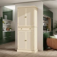 a tall cabinet in the middle of a room next to a kitchen with green cabinets