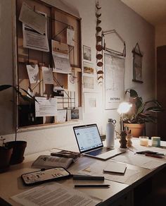 a desk with a laptop and papers on it