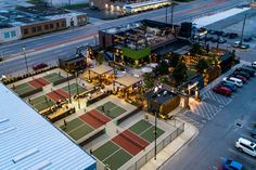 an aerial view of a tennis court and parking lot