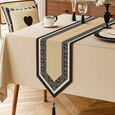 the table is set for two with black and white decorations on it, along with a heart - shaped pillow