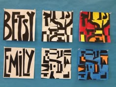 four pieces of art that are on a blue tablecloth with black and white letters