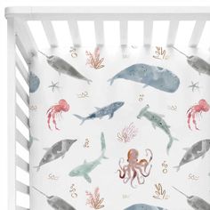 an ocean themed crib bedding set with marine animals and octopuses on it